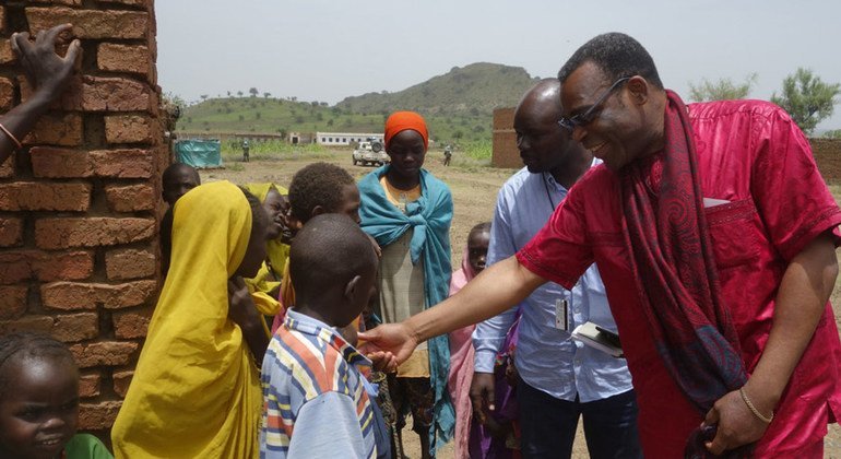 Marcel Clement Akpovo (right), UNAMID Chief of Human Rights, is interacting with IDPs at Aralciro IDP gathering site during his recent visit to Golo, Central Jabal Marra locality, Darfur, Sudan.