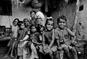 An elderly couple surrounded by their grandchildren in the Banjara tribal community near Hyderabad. 1981.