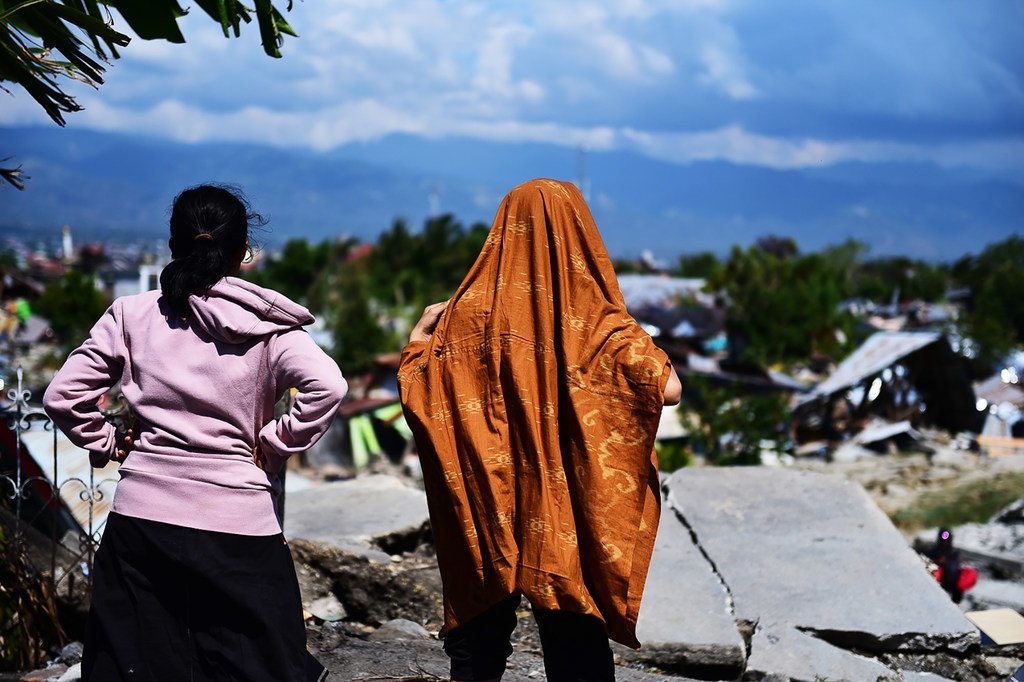 People look at destroyed buildings in West Palu, central Sulawesi, in the aftermath of an earthquake and tsunami that struck the island in September 2018.
