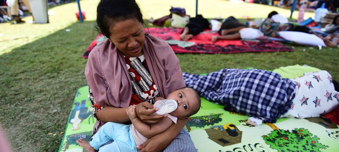 Five-month-old Asifa Humaira is given milk by her mother in an evacuation tent on the RRI office yard on Jalan Kartini, East Lolu, Palu City, Central Sulawesi, Indonesia (2 October).