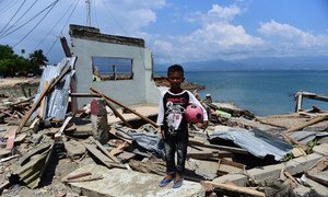 Rido Saputra, 10 years old, stands in front of his home which was destroyed by the tsunami in Donggala Regency, Central Sulawesi, Indonesia (3 October).