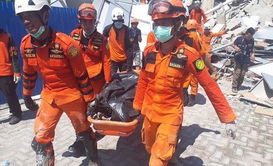 A team from the Indonesian National Search and Rescue Agency recovers a body from the wreckage of a building destroyed in an earthquake which struck Sulawesi in September 2018.  