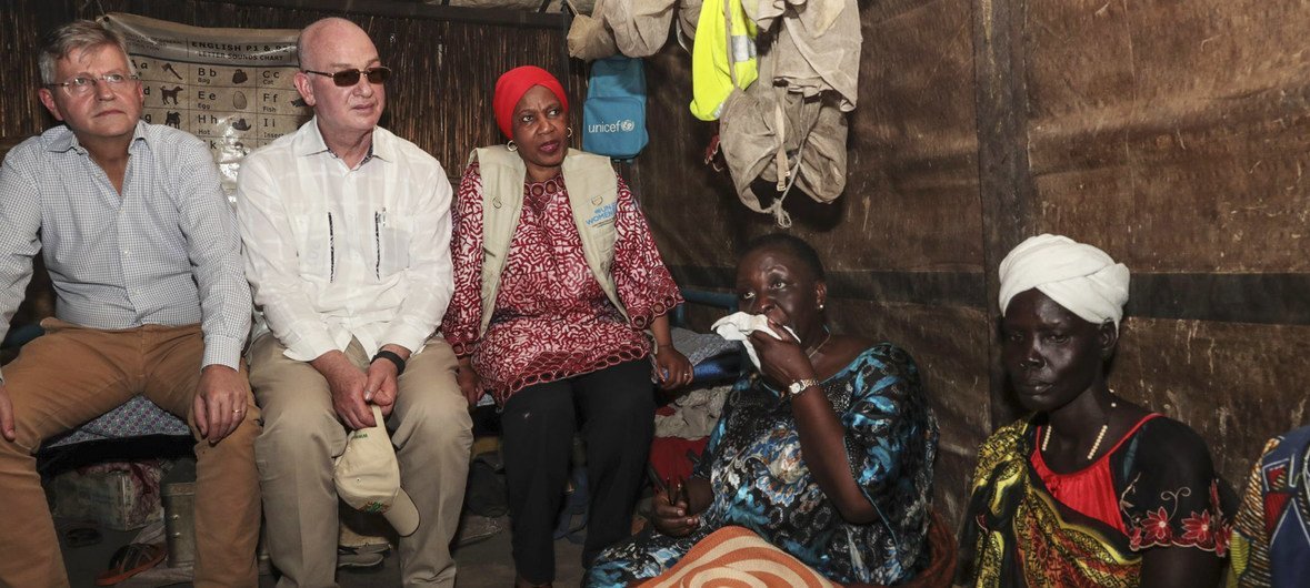 A high-level delegation from the United Nations and African Union meets Nyamile Malual Jiech (far right) who walked with her children through violent clashes to reach the safety of the United Nations protection site in Bentiu in the north of South Sudan.