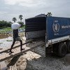 Life-saving food supplies are loaded from a river barge onto trucks destined for distribution in Malakal town, South Sudan.