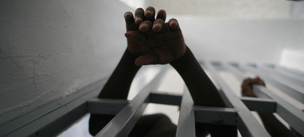 Boys reach through bars at a jail for juveniles in the Delmas neighbourhood of Port-au-Prince, Haiti. 2005