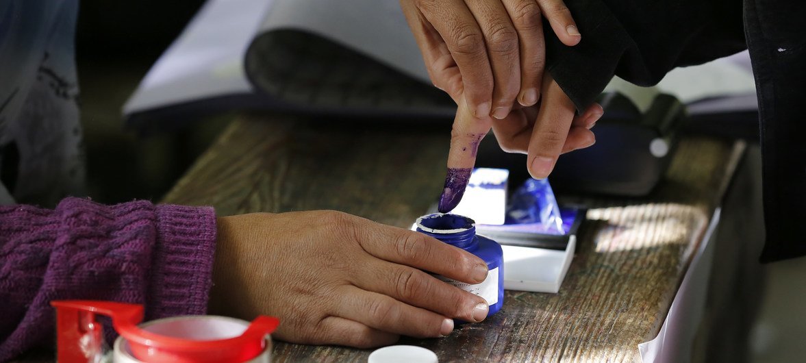 A woman at a voting centre in Kabul dips her finger in indelible ink after casting her vote in Afghanistan’s parliamentary elections.