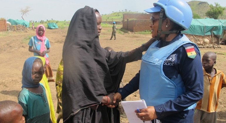 A peacekeeper is interacting with Internally Displaced Person at Aralciro gathering site, Golo locality, Central Jabal Marra, Darfur, Sudan.
