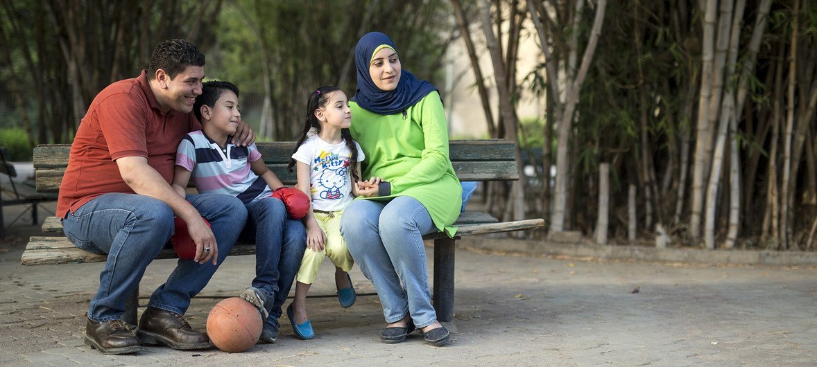 Ahmed and Rasha enjoying a picnic in the Japanese Park in Helwan neighborhood in Cairo, Egypt, with their two children, Mohamed and Raghad.  Ahmed and Rasha have chosen to not have any more children because they want to ensure they can provide Ahmed and R