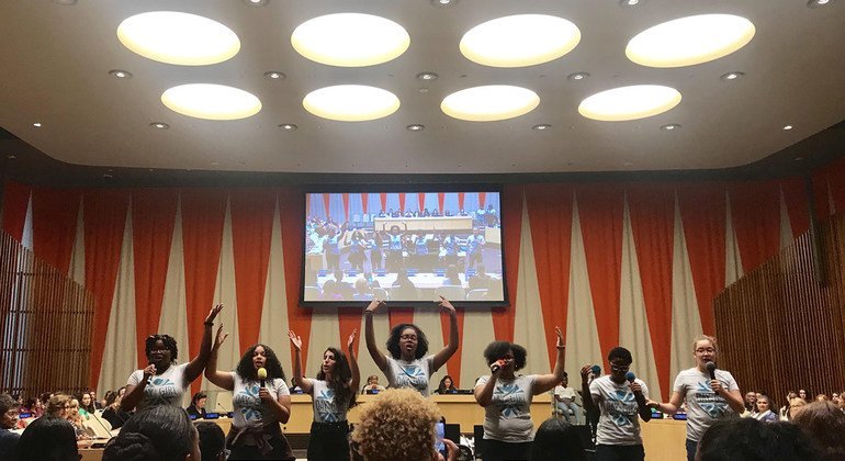 A group of teen advocates for girls rights perform a skit on the barriers women and girls face in social life, school, and the workforce during the 