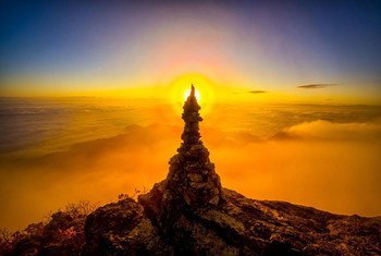 Stone tower with solar halo at sunrise at Kimso Mountain, Republic of Korea.