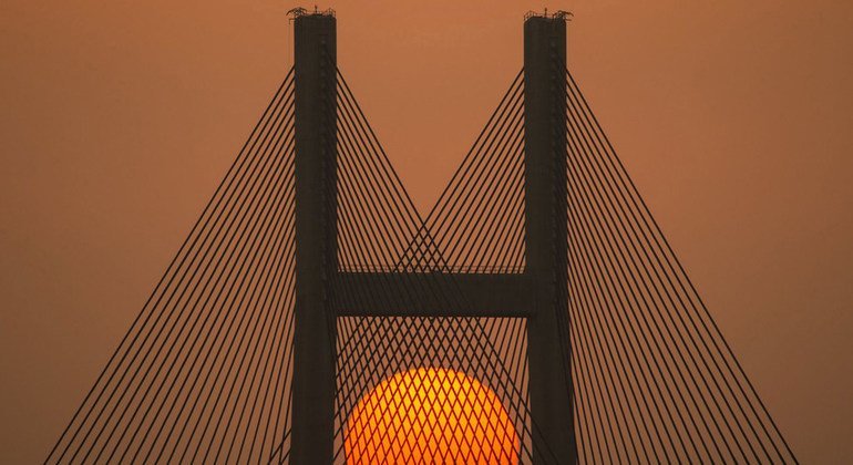 The sun sets behind the a bridge at Sai Tso Wan in Hong Kong.