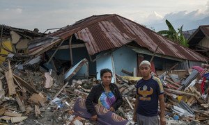 Thirty-one-year-old earthquake survivor, Mega (left) and her husband, search through the wreckage of her childhood home in Petobo village, Palu, in the Indonesian island of Sulawesi.  16 October 2018.