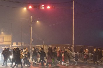 At dawn, parents and children cross the road on their way to school in the Songinokhairkhan district, Ulaanbaatar, Mongolia, where the air pollution level is the highest in the city.