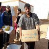 WFP distribute food near Rukban in Syria where an inter-agency (UN and SARC) convoy arrived on Saturday with more than 70 trucks, including 43 WFP trucks.