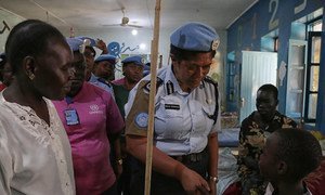 Unaisi Bolatolu-Vuniwaqa (centre), United Nations Mission in South Sudan (UNMISS) Police Commissioner, and women from United Nations Police (UNPOL) Women's Network, visit Juba Children's Hospital and Juba Teaching Hospital where they make donations of non food items..The Police Commissioner greets a child.