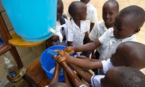 Learning that handwashing is among the best ways to protect yourself against Ebola, school children in Beni, DR Congo visit a UNICEF hand-washing station at their school.