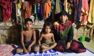 A Rohingya refugee from Myanmar, sits with two out of her four children in their shelter at Nayapara camp, south-east Bangladesh.