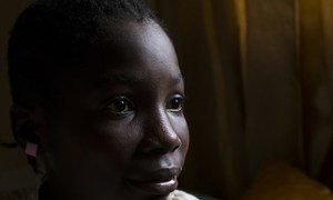 Stella, 12, sits on the bed she shares with her two siblings and mother. She was born in Nigeria but her birth was never registered.  Now living in Liberia, after the passing of her Nigerian father, she cannot prove ties to either country.