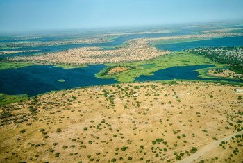 Aerial view over Lake Chad from the aeroplane, clearly shows patched of desertification. In the past 50 years, Lake Chad basin shrank from 25,000 square kilometers to 2,000 square kilometers.
