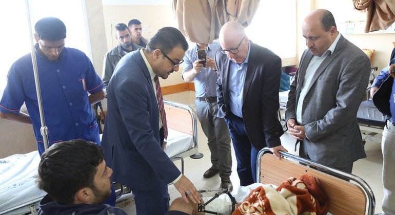 UN Humanitarian Coordinator for the Occupied Palestinian Territory visits patients in Al-Shifa Hospital in Gaza, along with doctors and WHO's representative.