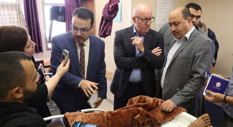 UN Humanitarian Coordinator for the Occupied Palestinian Territory, Jamie McGoldrick, visits patients in Al-Shifa Hospital in Gaza, along with doctors and WHO's representative.  Pictured l to r: UN News's Reem Abaza, Dr. Mattar and Jamie McGoldrick.