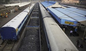 A new report has urged countries to cut the production of fossil fuels by 6 per cent, per year, to avoid catastrophic global warming. Pictured here, a cargo train, laden with coal, waits at a railway station in India. (file photo)