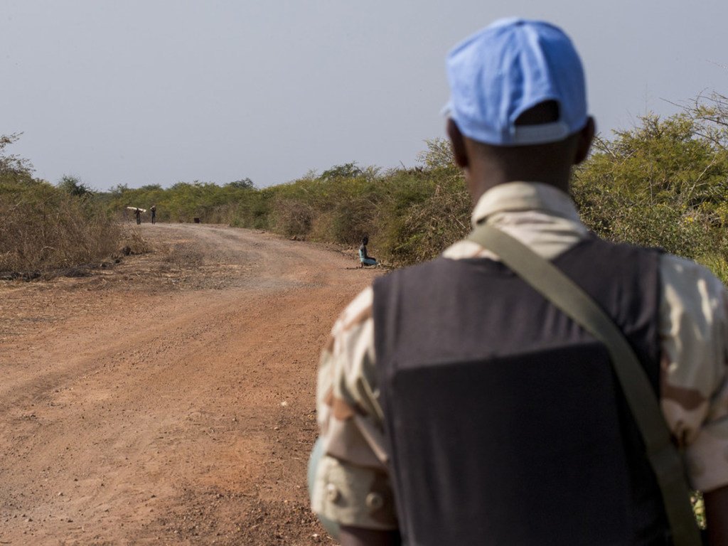 In this file photograph, an UNMISS peacekeeper patrols a road near Bentiu, Unity state, South Sudan. Patrols such as these serve to show a presence and to provide protection in the area.