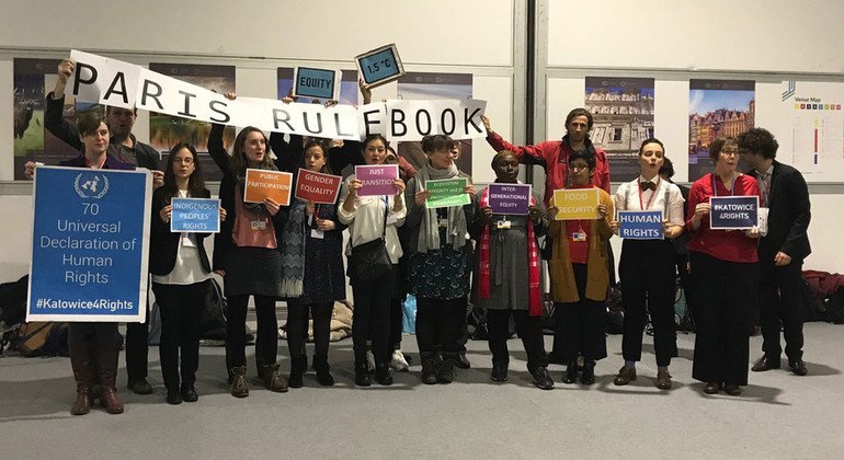 Civil society representatives at the COP24 climate conference in Katowice, Poland show their support for the Universal Declaration of Human Rights.