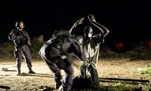 Abandoned buildings at the Barclay training center in downtown Monrovia, a notorious meeting point for drug dealers and users. Here, a suspect is identified and searched for drugs and weapons. (2008)