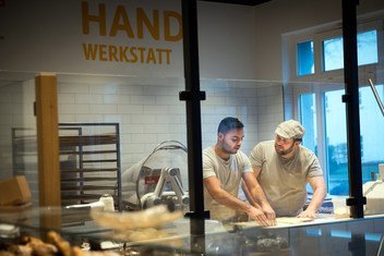Syrian refugee Mohamad Hamza Alemam (left) is receiving baking lessons from Master baker Björn Wiese (wearing cap), at the Backwerkstatt Bakery in Eberswalde, eastern Germany.  4 December 2018.