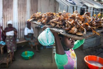A girl sells dry fish in New Kru town, Liberia.