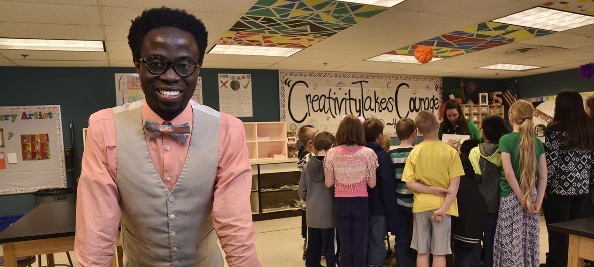 Bertine Bahige, 38, visits a classroom of students in Rawhide Elementary School where he serves as the principal after being resettled to the United States.