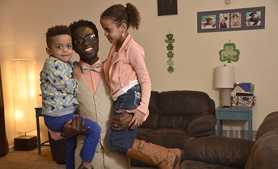 Bertine Bahige and his two children in their home in Gillette, Wyoming getting ready for the school day.