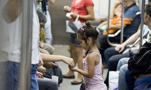 Five-year-old Kiara makes a sale in a commuter train car in Buenos Aires, the capital. She has been working in the Subte, the city’s mass transit system, selling hairpins and other cheap goods, since she was three years old.