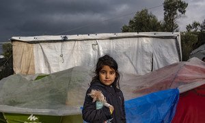 A young girl in front of her tent outside the Reception and Identification Centre in Moria in the Greek island of Lesvos.  15 December 2018.