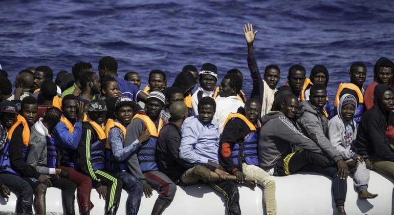 A boat full of refugees and migrants from across Africa waits to be rescued by the Sea Watch in Libya.