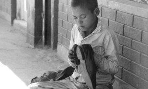 Young boy shining shoes in Kathmandu, Nepal (file).