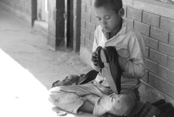 Young boy shining shoes in Kathmandu, Nepal (file).