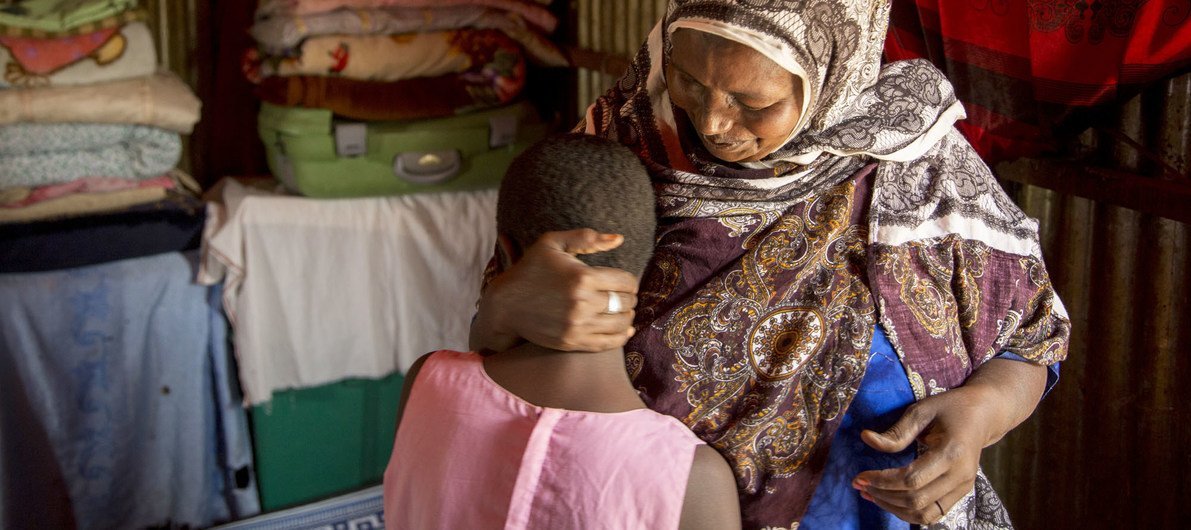 Female Genital Mutilation practitioner with her 10-year-old granddaughter in Diaami, Hargeisa in Somaliland. The young girl was supposed to have been cut already but she is sick with an infection so her grandmother is waiting. 