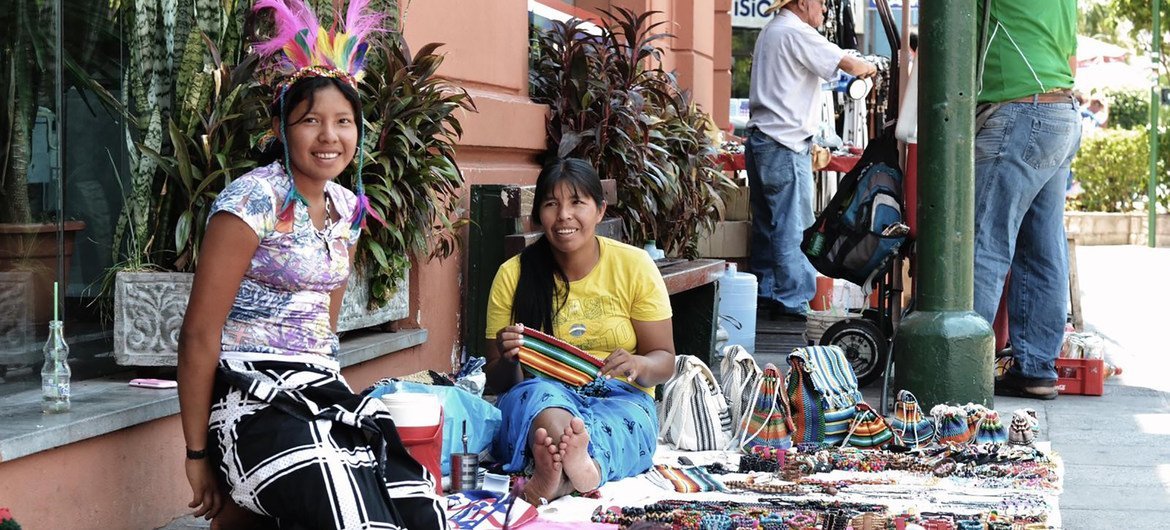 Dos jóvenes guaraníes venden artesanías en Asunción, Paraguay.