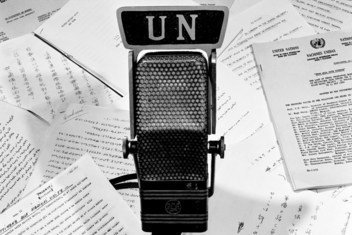 A microphone and a typical collection of scripts used by United Nations Radio in bringing to the peoples of the world reports on the various aspects of United Nations activities. August 1960.
