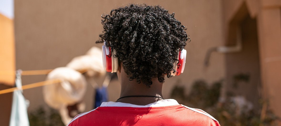 A young refugee from Eritrea, loves listening to songs in the headphones he found on his way to Niger. More than a billion risk irreversible hearing loss from playing music too loud on smartphones and other devices, WHO and the ITU have reported.