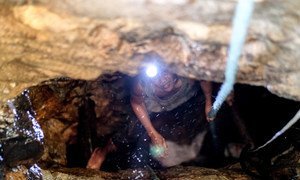 Camarines Norte, the Philippines: An artisanal miner ascends from a shaft in the hills outside of Paracale.