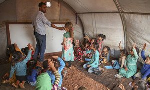 On 1 October 2018 at the Junaina makeshift camp in northern rural Idlib, in the Syrian Arab Republic, girls study in a tent school where a total of 350 children between the ages of 7 and 14 are able to go back to learning.