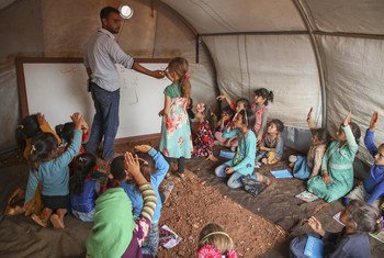 On 1 October 2018 at the Junaina makeshift camp in northern rural Idlib, in the Syrian Arab Republic, girls study in a tent school where a total of 350 children between the ages of 7 and 14 are able to go back to learning.