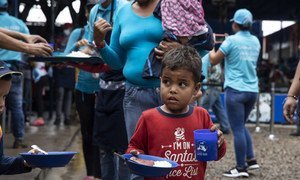 Venezuelan refugees and migrants near the Colombia-Venezuela border crossing queue for a meal at the Communal Kitchen Casa de Paso La Divina Providencia, supported by the UN refugee agency (UNHCR), where approximately 5,000 free meals are served to vulnerable Venezuelans on a daily basis 