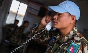 A peacekeeper serving in Juba calls home in May 2015 in the wake of the earthquake that struck Nepal. Amid the tragedy, the Nepalese contingent carried out their duties while they also grieved for those who lost their lives in the disaster. The UN Mission in South Sudan (UNMISS) made free calls available so Nepalese peacekeepers could stay in touch with loved ones back home.