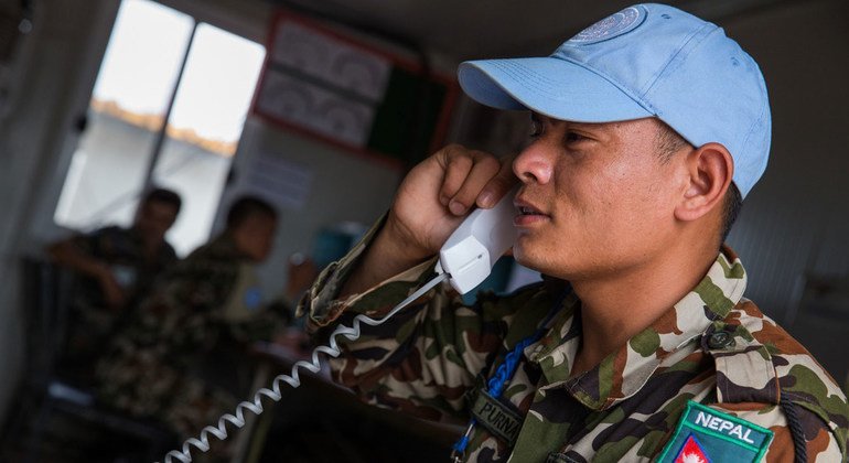 A peacekeeper serving in Juba calls home in May 2015 in the wake of the earthquake that struck Nepal. Amid the tragedy, the Nepalese contingent carried out their duties while they also grieved for those who lost their lives in the disaster. The UN Mission