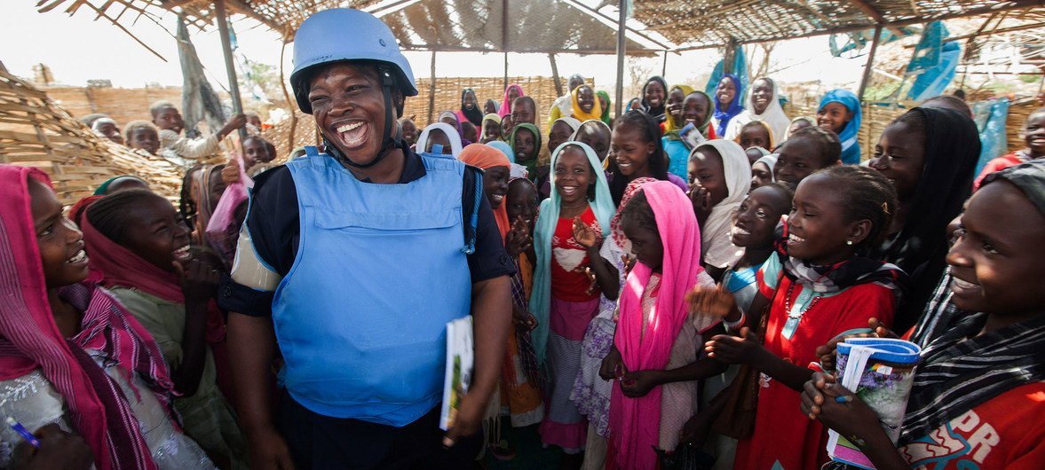 Ghana has been a consistent contributor to United Nations peacekeeping efforts since the 1960s. Seen here is Mary, a UN Police Officer from Ghana, as she greets children at the El Sereif camp for internally displaced persons in the Darfur region of Sudan 