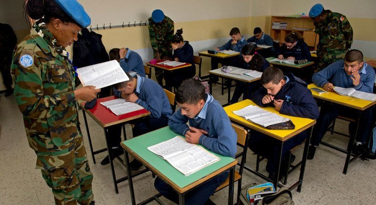 Corporal Akorpa Edzorhoho, a Ghanaian peacekeeper serving with UNIFIL, reads to students in her English class in Rmeish in March 2013.